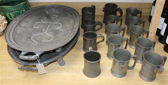 Two Victorian pewter venison dishes and a large collection of pewter mugs and measures